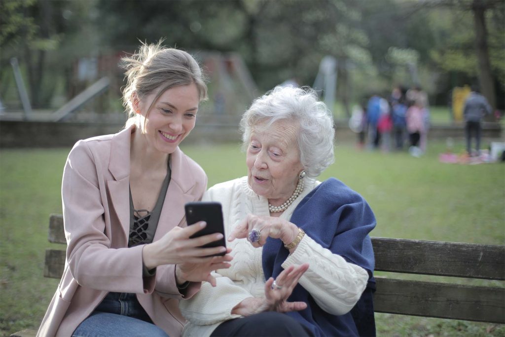 resident and care member on a bench