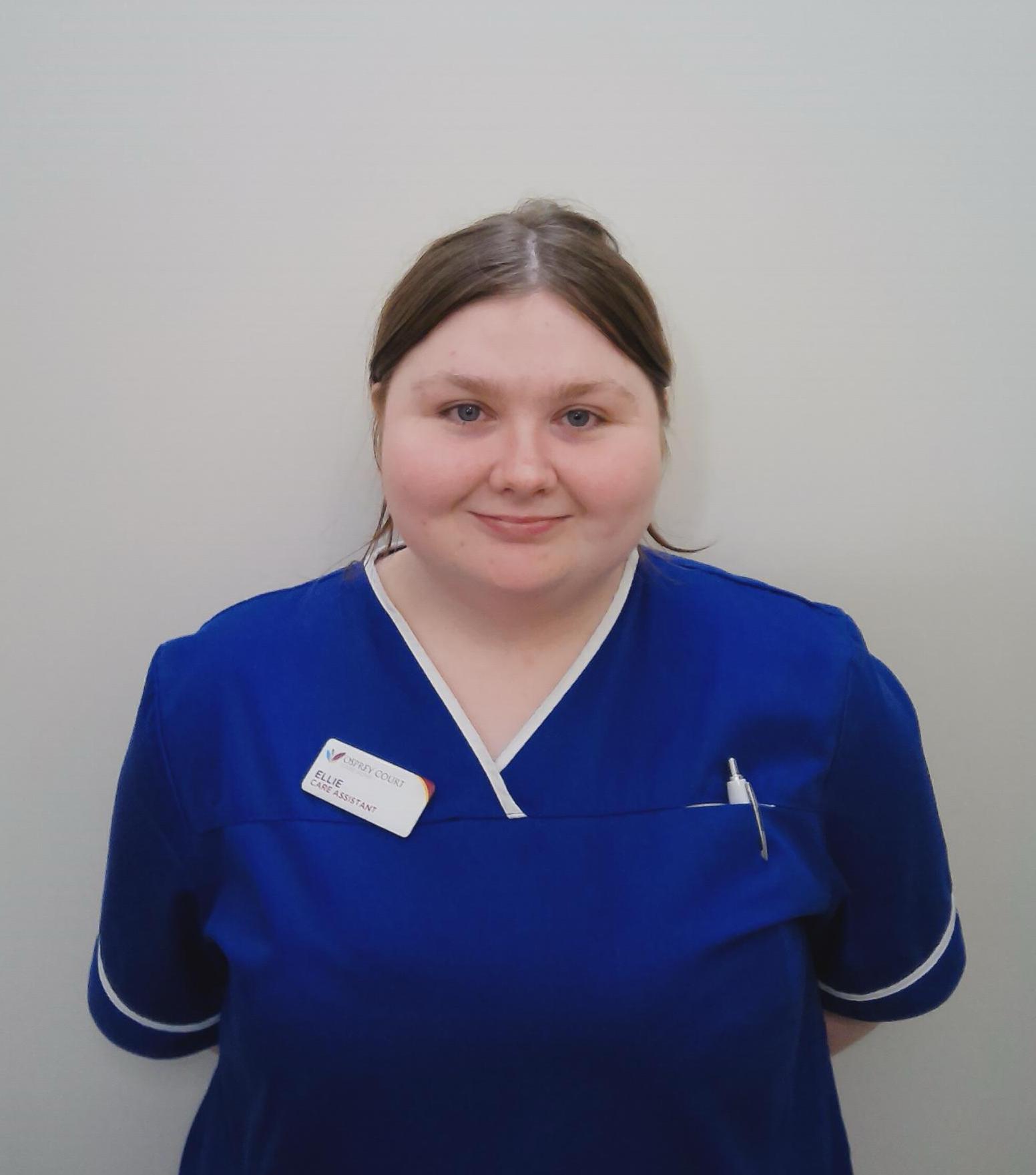 care home carer in blue nurse uniform
