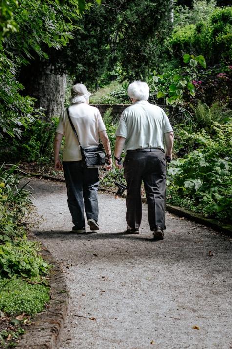 older couple walking down a path